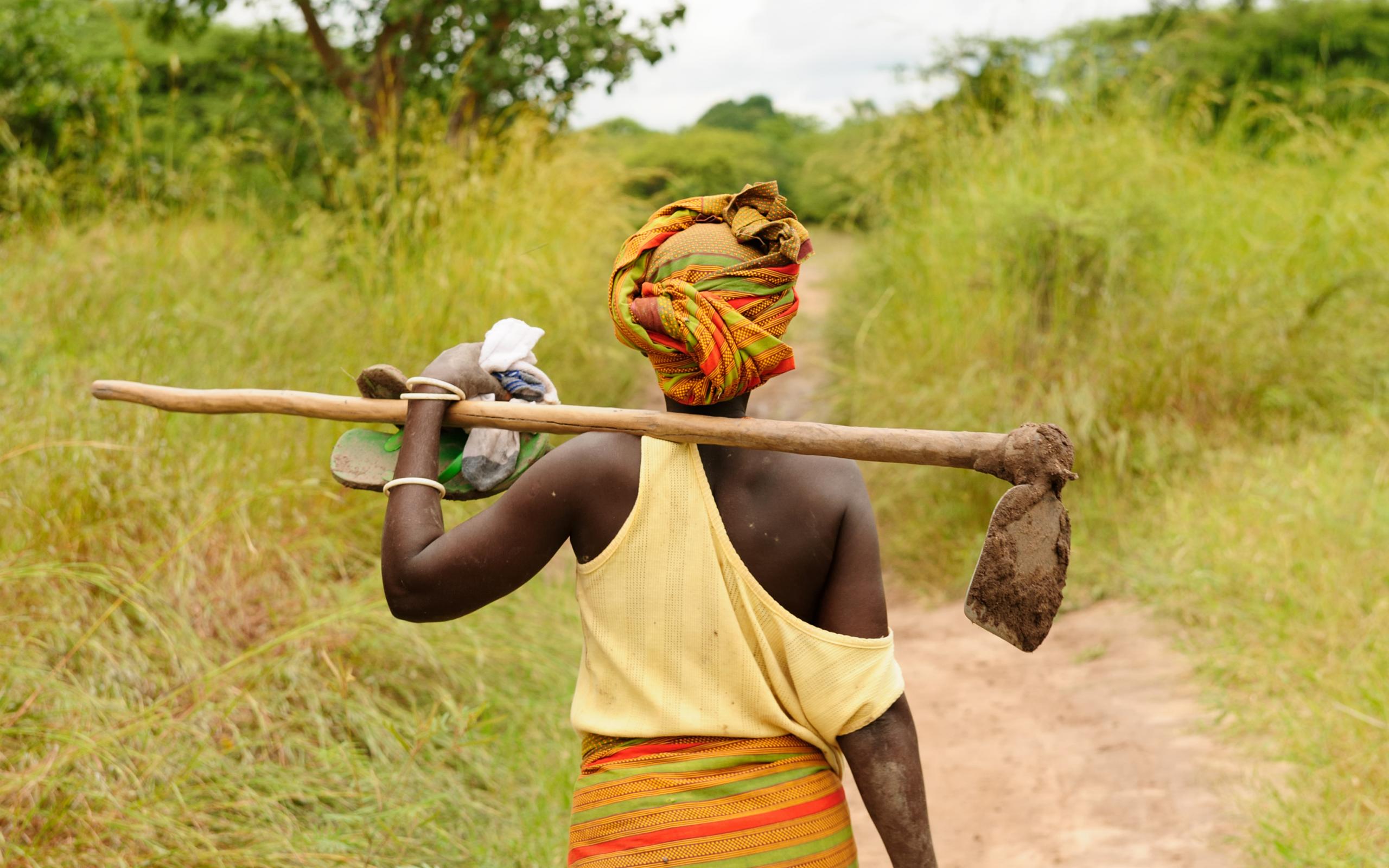 Woman walking with farm tool